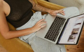 Person researching market trends on a laptop, exploring strategies to identify and fill consumer needs in 2025.