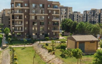 Modern apartment buildings and landscaped property showcasing real estate listings for brand growth through smart communication channels.